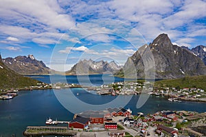 Aerial view of Reine, Lofoten islands, Norway. The fishing village of Reine. Spring time in Nordland. Blue sky. View from above