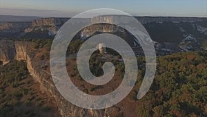 Aerial view on remains of an ancient observation tower in the mountains. Shot. Watch tower of the ancient city in the