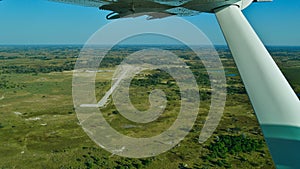 Aerial view of a remote airfield surrounded by bush land in Okavango Delta, Botswana from plane. photo