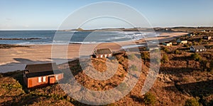 Aerial view of remote beach huts on the Northumberland coast at Embleton Bay