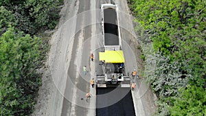 Aerial view on repair of a highway, the process of laying a new asphalt covering, Road construction works.