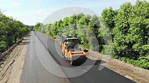 Aerial view on repair of a highway, the process of laying a new asphalt covering, Road construction works.