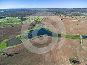Aerial view of reservoir for irrigation of a farm in Beas village between the pastures and green meadows of the province of Huelva