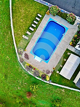 Aerial view of a residential backyard with a large rectangular swimming pool