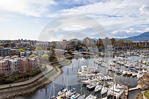 Aerial View of Residential Homes, Boats in Marina and Modern Cityscape.