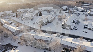 Aerial view of residential houses, condo, townhouses covered snow at winter season. Establishing shot of american neighborhood,