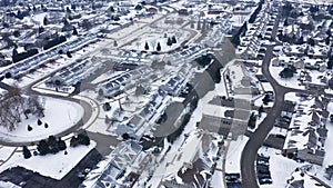 Aerial view of residential houses covered first snow. American neighborhood, suburb. Real estate, drone shots, day time, winter,