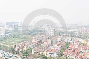 Aerial view residential houses and high-rise condominium building in foggy background