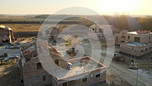 Aerial view of residential houses under construction in rural suburban area. Real estate development