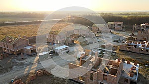 Aerial view of residential houses under construction in rural suburban area. Real estate development