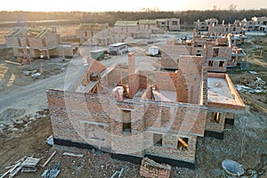 Aerial view of residential houses under construction in rural suburban area. Real estate development