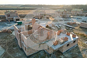 Aerial view of residential houses under construction in rural suburban area. Real estate development