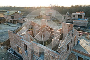 Aerial view of residential houses under construction in rural suburban area. Real estate development