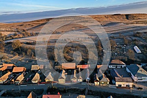 Aerial view of residential houses in a village during morning sunrise lights