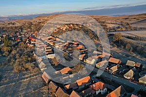 Aerial view of residential houses in a village during morning sunrise lights