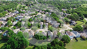 Aerial view residential neighborhood surrounded by matured trees and grassland in Flower Mound, Texas, US