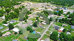 Aerial view residential suburbs houses in Checotah, McIntosh County, Oklahoma toward Broadway and Main Street with historic photo