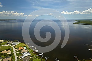 Aerial view of residential suburbs with private homes located on gulf coast near wildlife wetlands with green vegetation