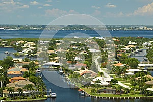 Aerial view of residential suburbs with private homes located on gulf coast near wildlife wetlands with green vegetation