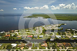 Aerial view of residential suburbs with private homes located on gulf coast near wildlife wetlands with green vegetation