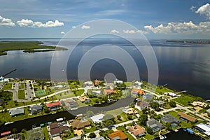 Aerial view of residential suburbs with private homes located on gulf coast near wildlife wetlands with green vegetation