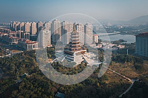 Aerial view of a retro style traditional Chinese pagoda tower, Jimei Tower in the Civic Park in Jimei District and city skyline