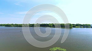 Aerial view revealing the bridge crossing the river and a boat on the water