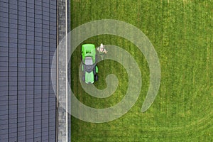 Aerial View of Riding Lawn Mower and Caucasian Gardener