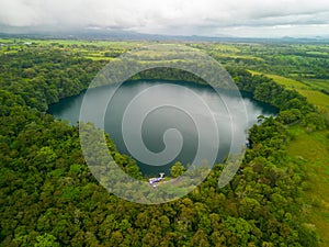 Aerial view of Rio Cuarto lake in Alajuela, Costa Rica, surrounded by dense greenery photo