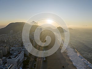 Aerial view of Rio de Janeiro, Copacabana beach. Skyscrapers beaches. Sidewalks and streets. Sugarloaf wrapped in cloud. Brazil