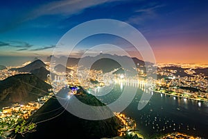Aerial view of Rio de Janeiro at night with Urca and Corcovado mountain and Guanabara Bay in Rio de Janeiro, Brazil photo