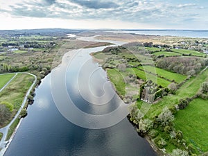 Aerial view on river Corrib and Menlo castle, Galway, Ireland, Warm sunny day, blue sky. Green fields and small forest. Irish