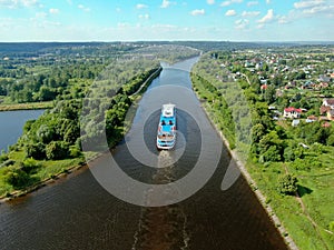 Aerial view river cruise ship sails along the river surrounded by beautiful green forest in summer on a sunny day Cruise Ship Trip