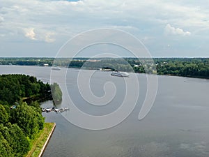 Aerial view river cruise ship sails along the river surrounded by beautiful green forest in summer on a sunny day Cruise Ship Trip