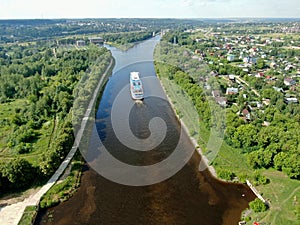 Aerial view river cruise ship sails along the river surrounded by beautiful green forest in summer on a sunny day Cruise Ship Trip