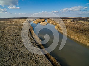 Aerial view of river flowing through forest in alpine valley in Kazakhstan