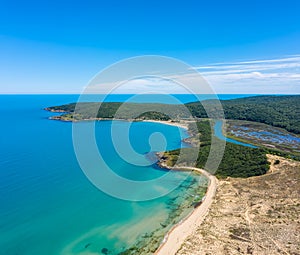 Aerial view with river that flows into the sea and sandy beach