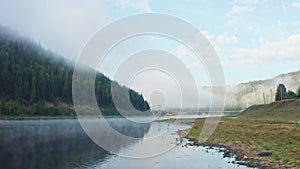 Aerial view of the river in the fog in the forest