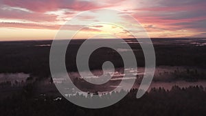 Aerial view of the river in the fog in the forest at dawn