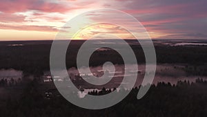 Aerial view of the river in the fog in the forest at dawn