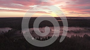 Aerial view of the river in the fog in the forest at dawn