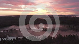 Aerial view of the river in the fog in the forest at dawn