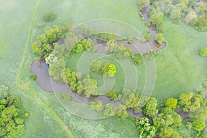 Aerial view of river meander in the lush green vegetation of the delta Top view of the valley of a meandering river among green