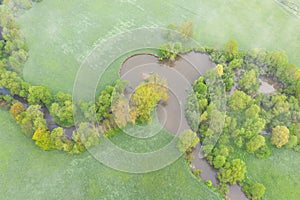 Aerial view of river meander in the lush green vegetation of the delta Top view of the valley of a meandering river among green