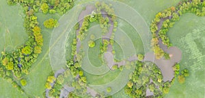 Aerial view of river meander in the lush green vegetation of the delta Top view of the valley of a meandering river among green