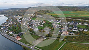 Aerial view of River Mosel surrounded by Wellen on a rainy day in Germany