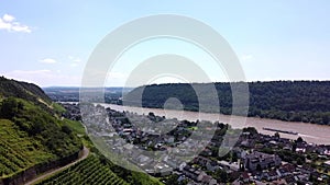 Aerial view of the River Rhine and the hills of a winery in western Germany and a small village in between.
