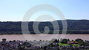 Aerial view of the River Rhine and the hills of a winery in western Germany and a small village in between.