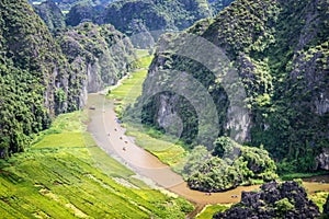 Aerial view of the river among rice fields and limestone mountains, vietnamese scenic landscape at ninh Binh Vietnam