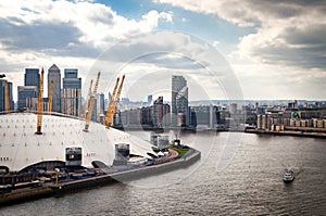 Aerial view of River Thames, North Greenwich and the Docklands on a cloudy day in London, England